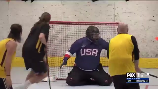 Players competing around a floorball goal at a PFC game night